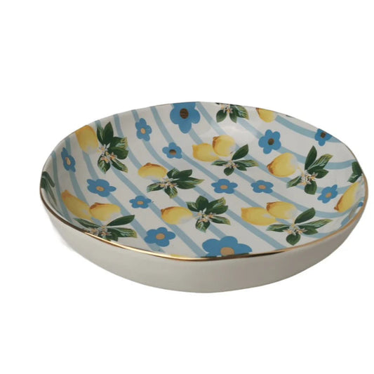 Decorative salad bowl with lemon and floral pattern on a white background