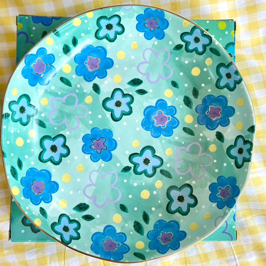 Decorative bowl with blue flowers on a yellow checkered background