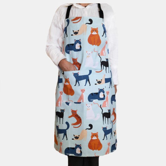Person wearing a colorful apron with cat pattern on a white background