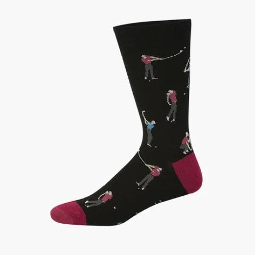 A single black crew sock with a repeating pattern of golfers in action, featuring magenta-pink toes and heels, shown against a plain white background.