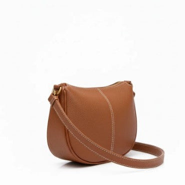 Brown leather handbag with a strap on a white background