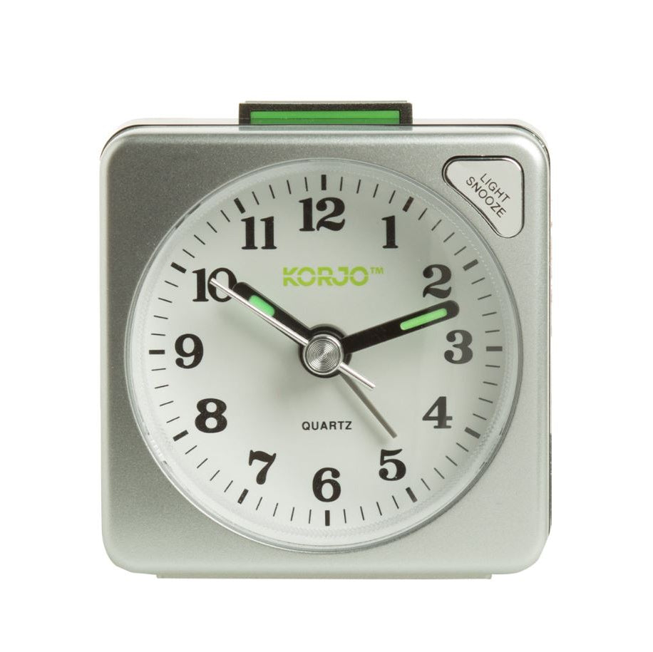 Silver alarm clock with white face and green accents on a white background