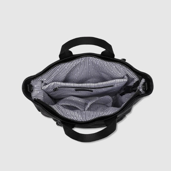 Black backpack with open front compartment on a light gray background