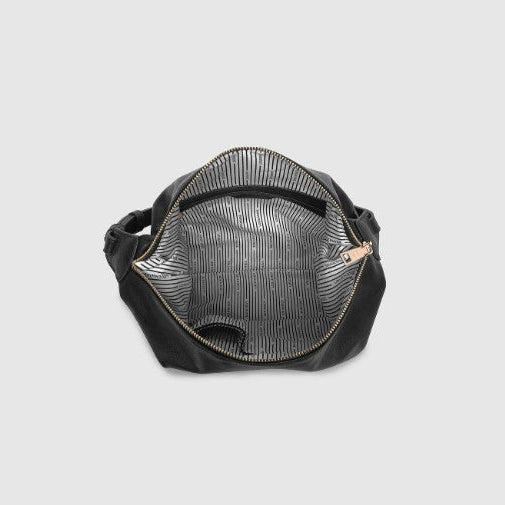 Black handbag with gold zipper on a light gray background