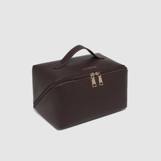Brown toiletry bag with gold zipper on a light gray background