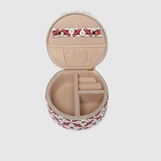 Round jewelry case with floral pattern on a light gray background