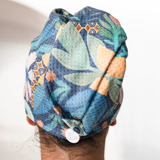 Colorful quick dry hair wrap worn a person's head against a white background