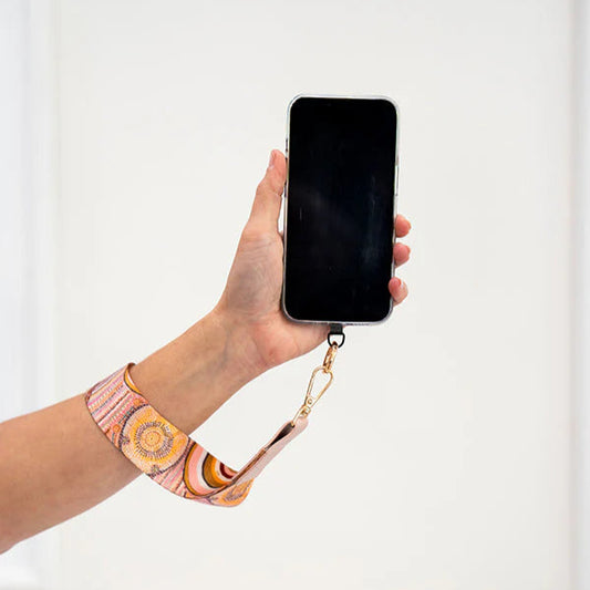 Hand holding a phone with a colorful strap against a white background