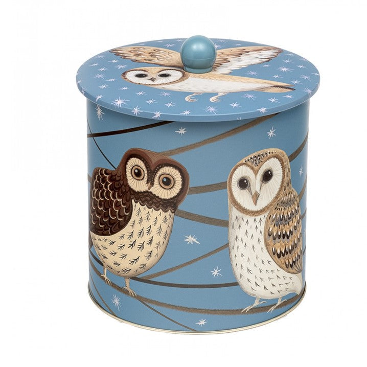 A cylindrical tin with a lid, decorated with two owls perched on branches against a light blue background with white star details. The lid features a matching illustration of an owl and a round blue knob.
