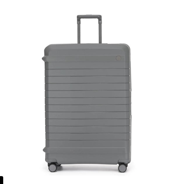 Gray suitcase with wheels on a white background