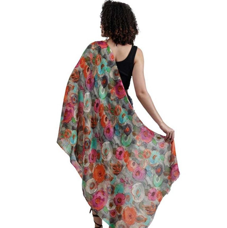 Woman wearing a colorful floral scarf on a white background