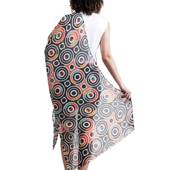 Woman wearing a sleeveless dress with a colorful circular pattern on a white background