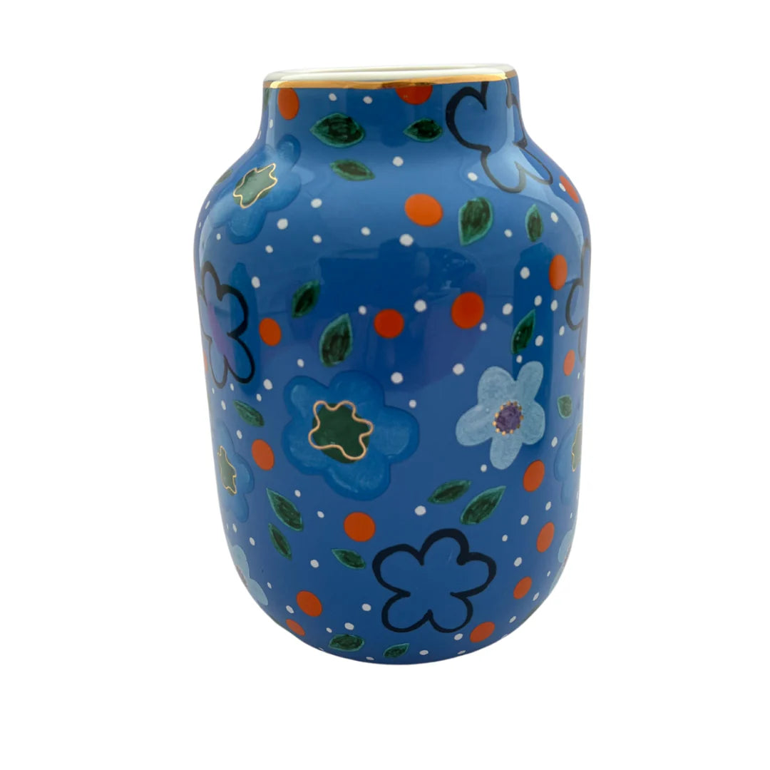 Blue ceramic vase with floral patterns on a white background