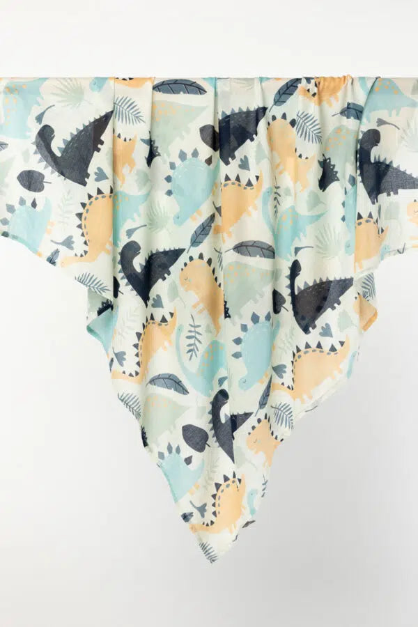 Indus Design Dinosaur Baby Swaddle - Cotton in Natural, Indigo, and Duck Egg."