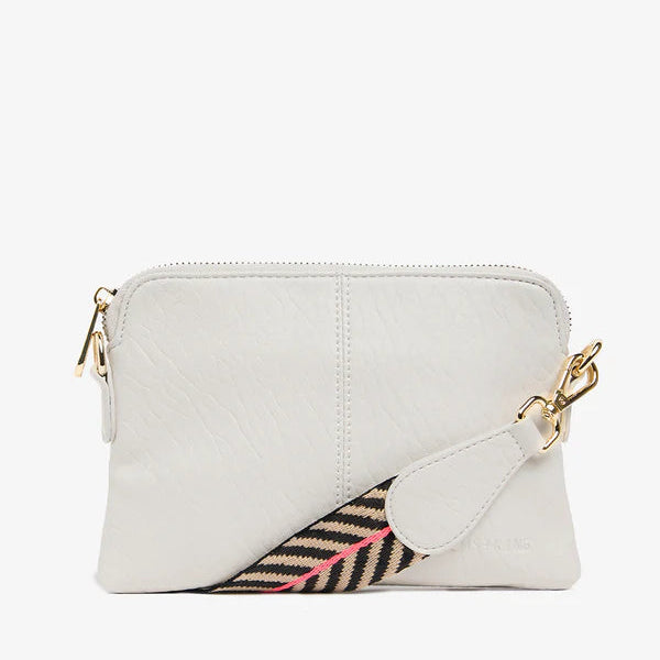 White crossbody bag with a colorful flap on a white background