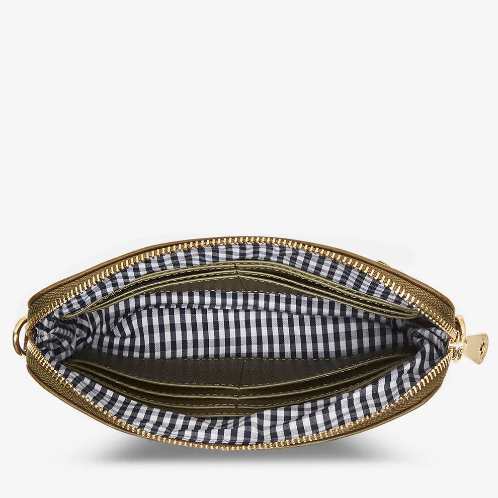 Khaki clutch with gold zipper and black and white checkered interior on a white background