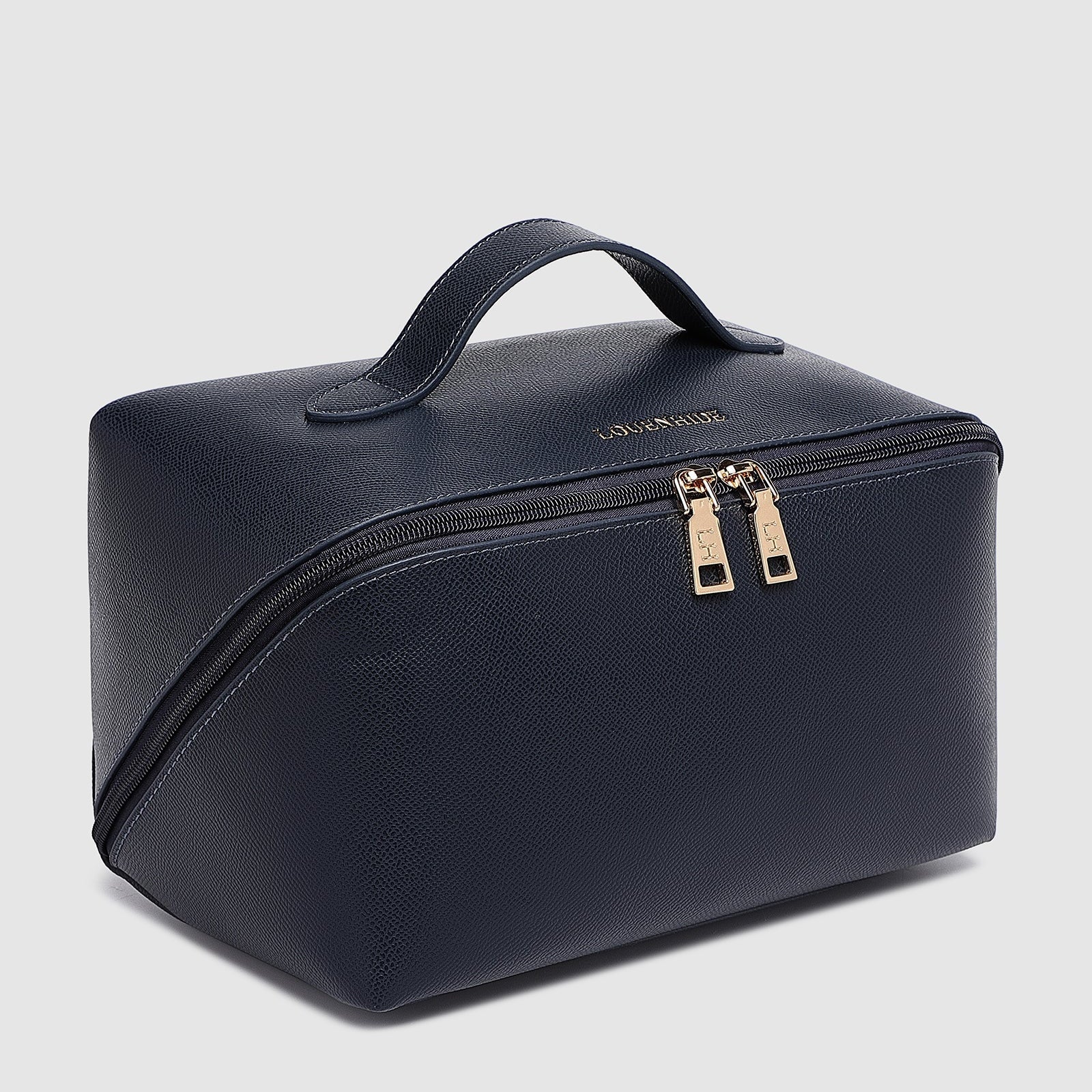 Navy toiletry bag with gold zippers on a light gray background