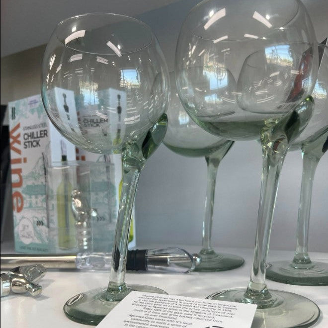 Clear wine glasses on a white surface with a blurred background