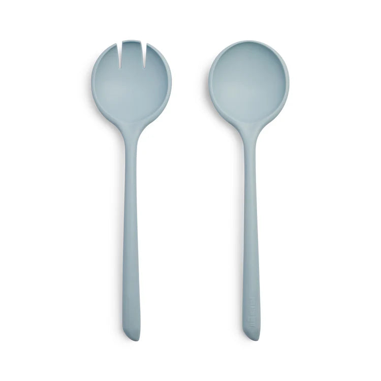 Two light blue salad servers on a white background
