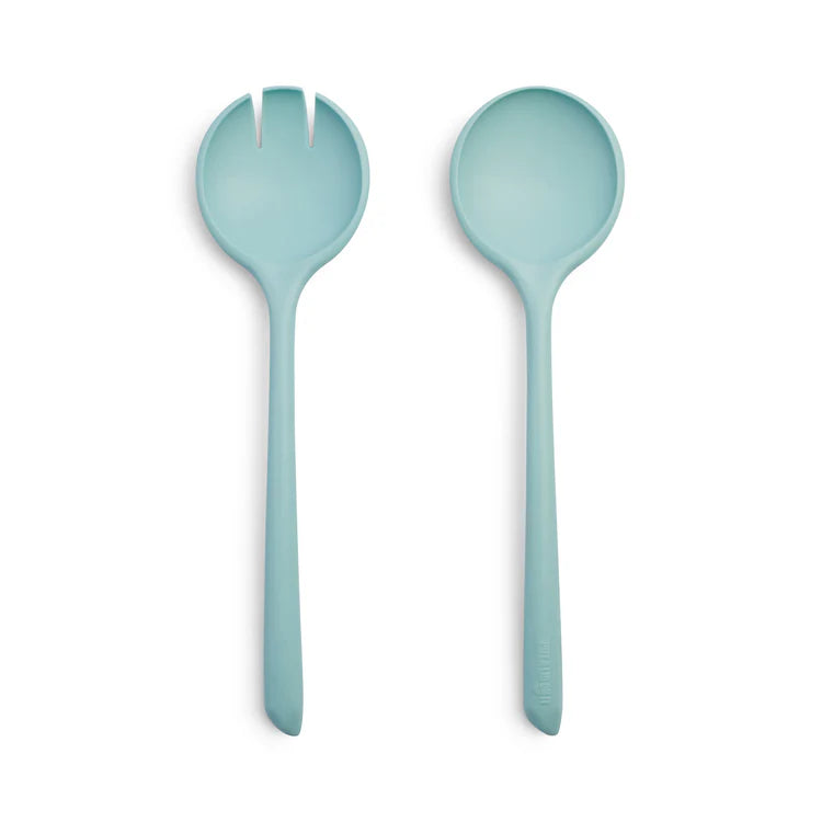 Two light blue salad servers on a white background