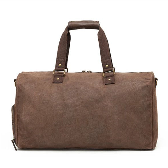 Brown duffel bag with leather straps on a white background