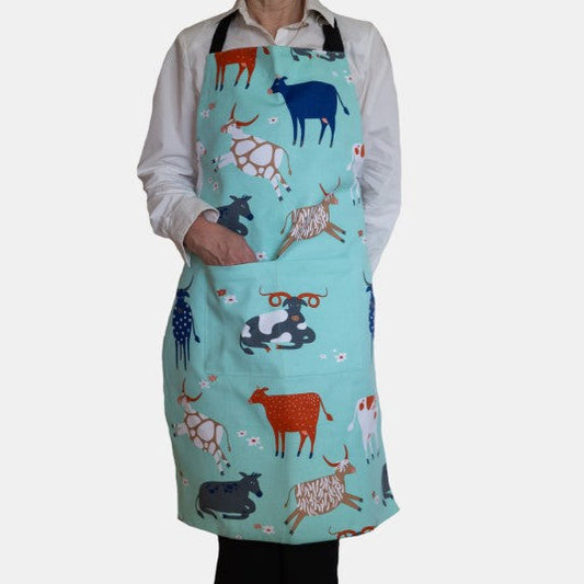 Person wearing a colorful apron with animal patterns on a white background