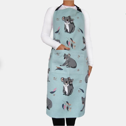 Person wearing a light blue apron with koala designs on a white background