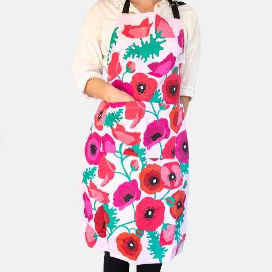 Person wearing a colorful floral apron on a white background