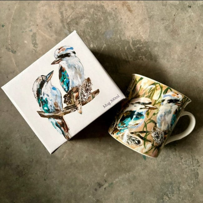 Mug with bird design on a matching box against a textured surface