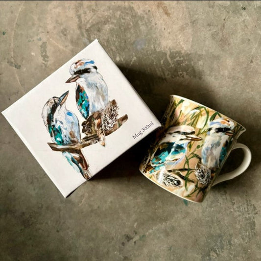 Mug with bird design on a matching box against a textured surface