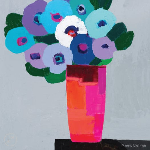 Colorful paper flower bouquet in a pink and orange vase on a light gray background.