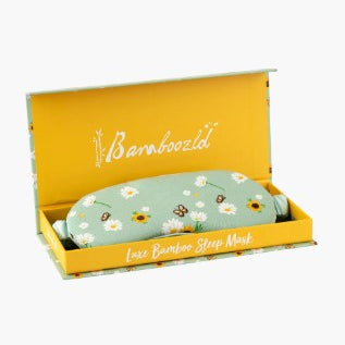 Bamboo Sleep Mask in a yellow Bambooooli box, featuring a light green mask with a daisy and bee pattern.
