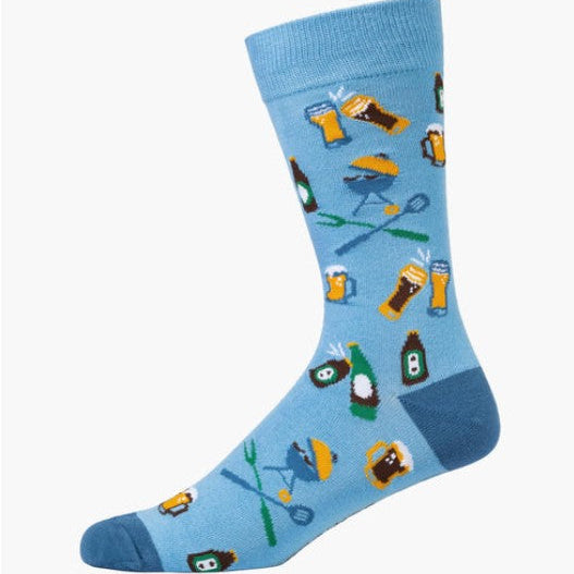A single light blue crew sock with a repeating pattern of beer glasses, bottles, grills, and utensils, shown on a plain white background.