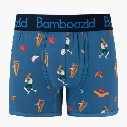 Blue trunks with an all-over cricket-themed print, featuring a dark navy waistband with the brand name 'BambooZld' in blue.