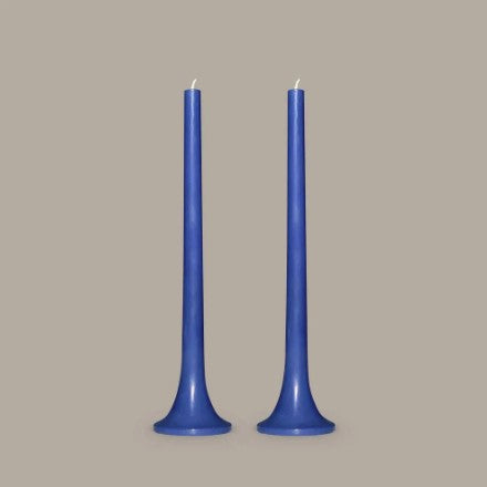 Two blue candles on a gray background