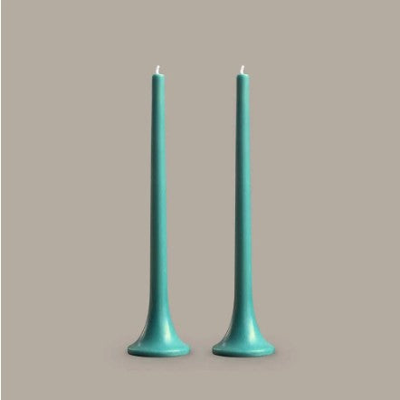 Two teal candles on a gray background