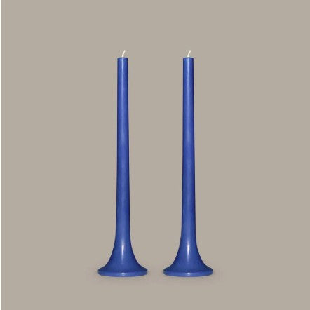 Two blue candles on a gray background