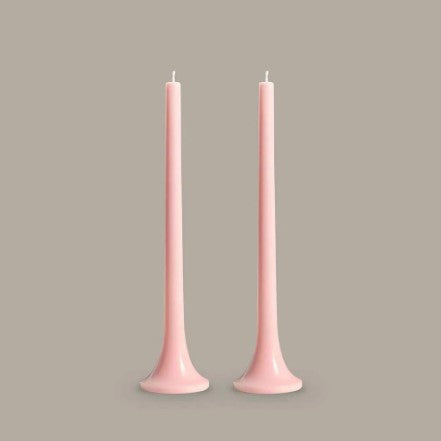 Two pink candles on a gray background