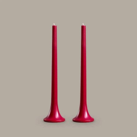 Two red candles on a beige background
