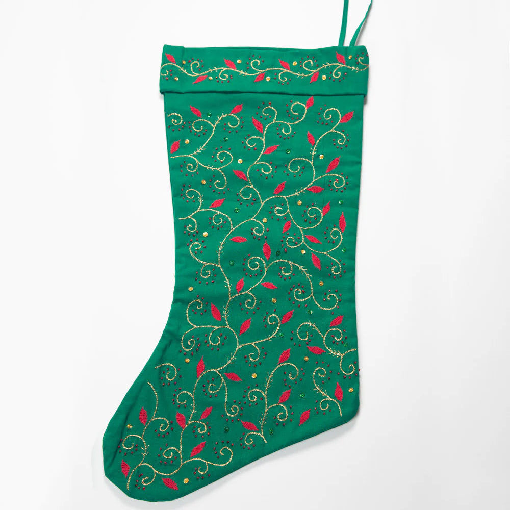 Green Christmas stocking with decorative patterns on a white background