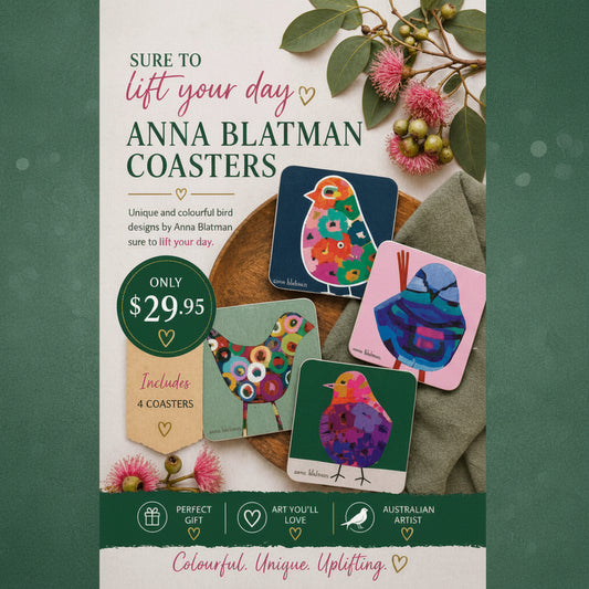 Coasters with colorful bird designs by Anna Blatman on a wooden surface with flowers.