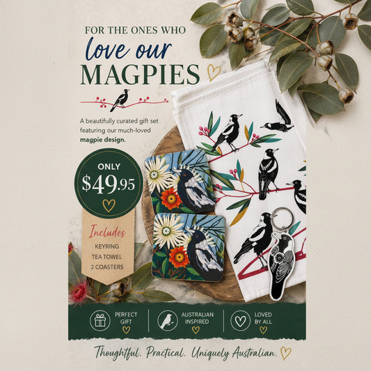 Gift set with magpie design including keyring, tea towel, coasters on a wooden surface.