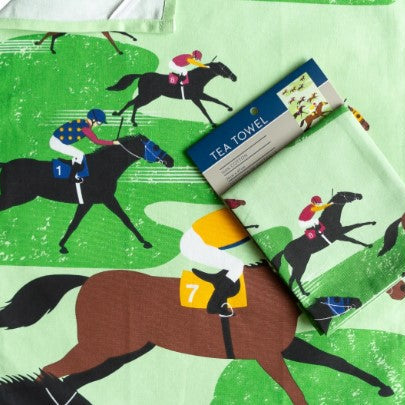 Tea towel with horse and jockey design on a green background