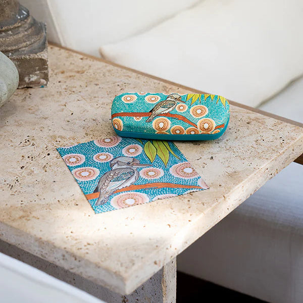 Colorful case with bird design on a stone surface