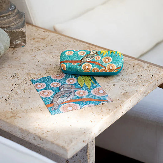 Colorful case with bird design on a stone surface
