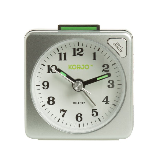 Silver alarm clock with white face and green accents on a white background