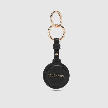 Black keychain with gold rings on a light gray background