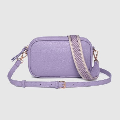 Lavender crossbody bag with a textured strap on a light gray background