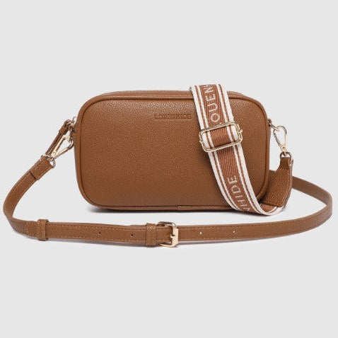 Brown crossbody bag with a strap on a light gray background