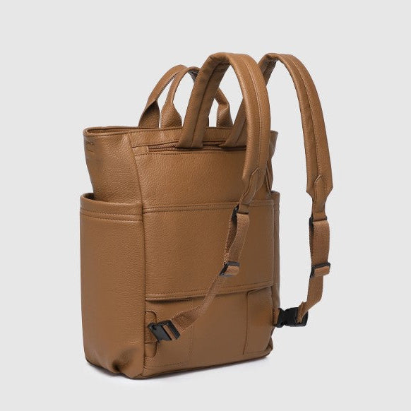 Brown leather backpack on a light gray background
